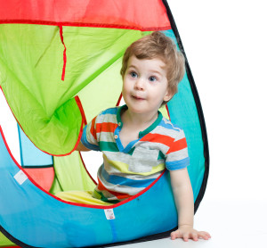 little boy playing in a tent